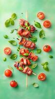 Meat skewers displayed with fresh basil cherry tomatoes on green surface. Recipe idea photo