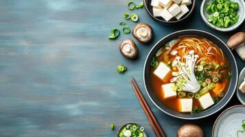 Miso soup with tofu and mushrooms, healthy meal preparation and plating with copy space photo