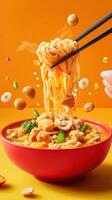 Noodle meal lifted with chopsticks over a bowl with ingredients falling on a colorful background photo