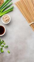 Noodles, soy sauce, and onion flat lay on table surface, food preparation background photo