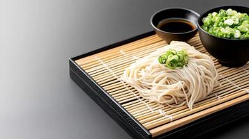Noodles with sauce and chives, placed on a bamboo mat. Can be used in food recipes photo
