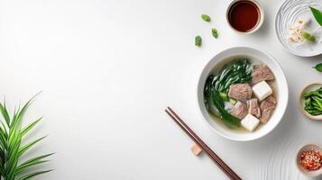 Noodles with vegetables and tofu on white surface, for website header or food blog photo