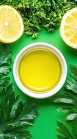 Olive oil in bowl with lemon parsley on green background for cooking or culinary use photo