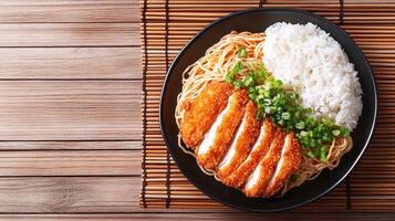 Overhead shot of noodles with beef cutlet and rice on a place mat for menu use photo