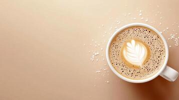 Overhead view of latte art in white mug on beige table with sugar sprinkling for beverage background photo