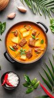 Overhead view of curry dish, with coconut, garlic, and greens, ready to be served and enjoyed photo
