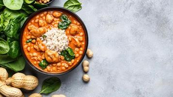 Peanut stew with rice and spinach, in a bowl, used to show a healthy meal option photo