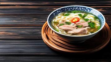 Pho soup with beef served in a bowl on wooden base. Used in menus, blogs and advertising photo