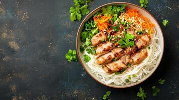 beef with noodles and veggies in a bowl on dark background. Lunch or dinner menu photo