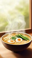 Ramen bowl with eggs and chives sits in front of a steamy window. Food blog image photo