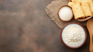 Rice porridge with crackers on a brown background. Possible breakfast option photo