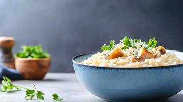 Risotto with mushrooms parsley served in bowl on table, dark background. Use Restaurant menu photo