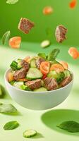 Salad with Beef, cucumbers and tomatoes floating on a green background. Food concept photo