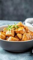 Savory chicken bites served in bowl. Use for food photography. Simple gray background photo