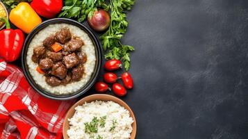 Savory stew with rice and colorful peppers on a dark surface with herbs, used for food blog photo