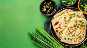 Scallion pancakes with sauce and green onions for lunch, on table. Stock photo use for food blog
