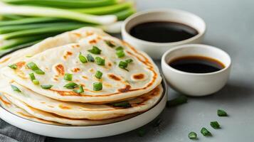 Scallion pancakes with soy sauce, top view, on table, food photography for cooking website photo