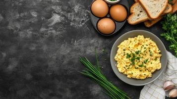 Scrambled eggs breakfast on grey table with bread and parsley, healthy food, cooking background photo