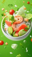 Shrimp and vegetable salad with noodle in a bowl on green background for food advertising use photo