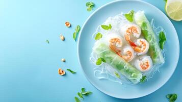 Shrimp spring rolls on a blue plate for healthy eating in a bright setting photo