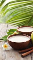 Spa treatment two bowls of cream on a wood table with flowers, with palm trees in the background photo