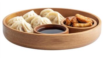 Steamed dumplings with sauce fried side dish are served in a wooden bowl. Meal idea photo
