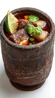 Stew of meat and vegetables in an ethnic-style bowl with a lime slice, for a magazine illustration photo