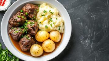Stew with mash and potatoes, served on a plate for lunch, on a black background, for a food blog photo