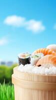 Sushi served in a wooden bucket, resting on grass with a blue sky and blurred city view in the background photo
