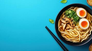 Tasty ramen bowl with egg, mushrooms and greens on a blue background, for a food blog post photo