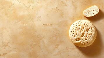 Top view of toasted flatbread with slice on textured surface, ideal for breakfast photo