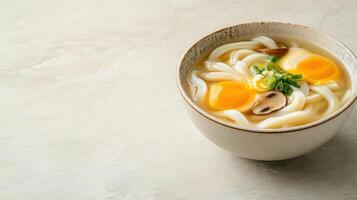 Udon noodle soup served with eggs and mushrooms in a bowl on bright table for asian food concept photo