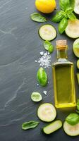 Zucchini slices with olive oil and basil leaves on a dark slate background photo