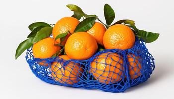 Vibrant Blue String Bag Holding Fresh Tangerines With Green Leaves On White Table Surface. A Fresh And Colorful Display photo