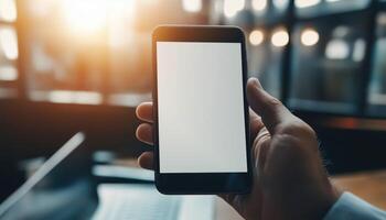 Over The Shoulder View Of Businessman Holding Smartphone And Working On Laptop With Digital Tablet In Modern Office For Website Or Application, Mockup Image. photo