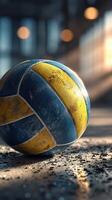 Volleyball resting on a dusty floor with sunlight streaming in during a late afternoon practice session photo