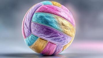 Colorful volleyball resting on a smooth surface with soft lighting highlighting its vibrant patterns and textures photo