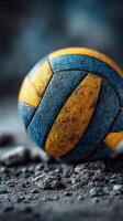 Textured volleyball on a sandy surface at a sports facility during a training session photo