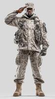 Soldier in camouflage uniform standing tall and saluting with pride in a neutral background photo
