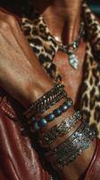 Stylish layered bracelets showcase unique designs under bright sunlight in an urban setting photo
