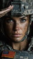 Female soldier in combat gear saluting, conveying strength and determination in an outdoor setting photo