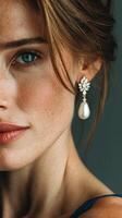 Model showcases elegant pearl earrings with a serene expression in close-up portrait shot under soft lighting photo