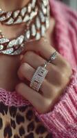 Elegant jewelry display featuring a dazzling ring and a statement necklace complemented by a cozy pink knit sweater photo