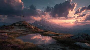 Vibrant sunset illuminates mountain landscape with cross and reflective water in serene setting photo