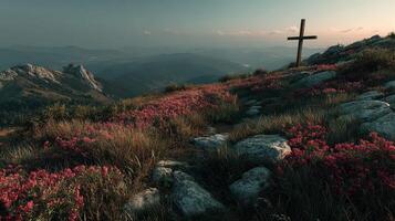 Cross stands amidst vibrant flowers and rocky terrain on a serene mountain landscape at dusk photo