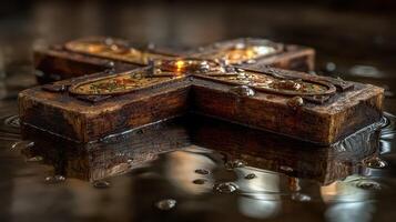 Wooden cross resting on water surface with reflections and droplets captured in tranquil setting photo