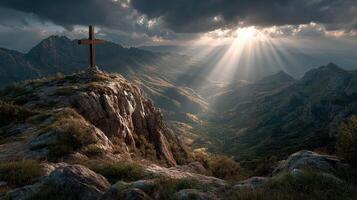 Scenic mountain landscape with a cross at sunset illuminating the valleys and peaks in a dramatic sky photo