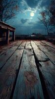 Nighttime view of a wooden dock under a bright moon with autumn leaves scattered on the floor and a calm lake in the background photo