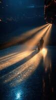 Skater prepares stage at a theater with golden light beams illuminating the ice surface photo