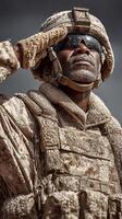 Military soldier salutes proudly in desert terrain during a clear day with intense sunlight photo